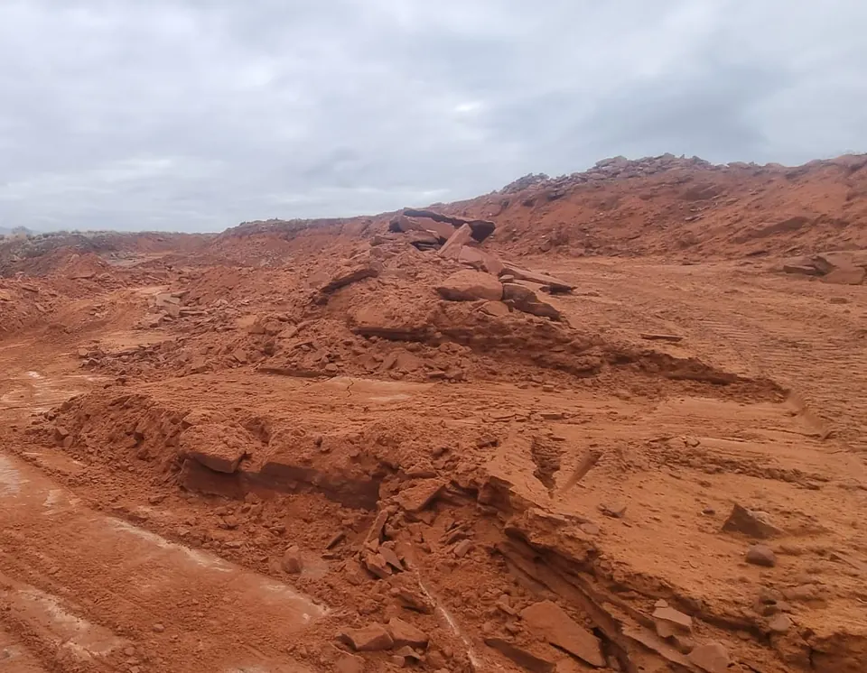 Excavator at work in the red sandstone quarry
